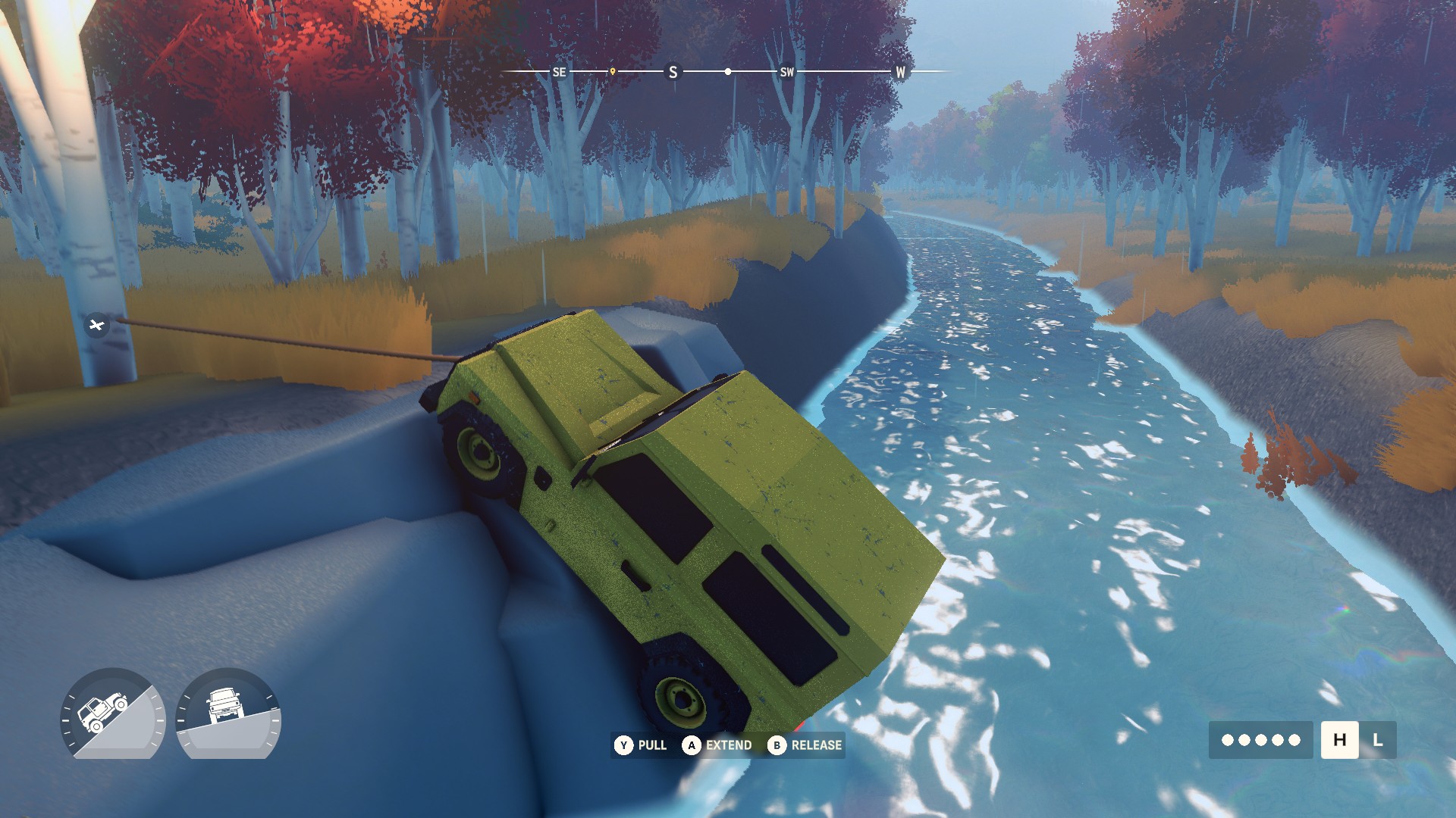 An over the hill vehicle using its winch on a tree while climbing out of a river