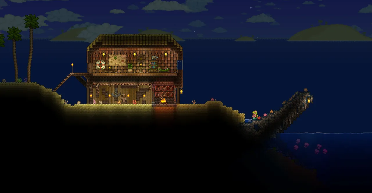 Official Terraria screenshot of a lit building beside water at night