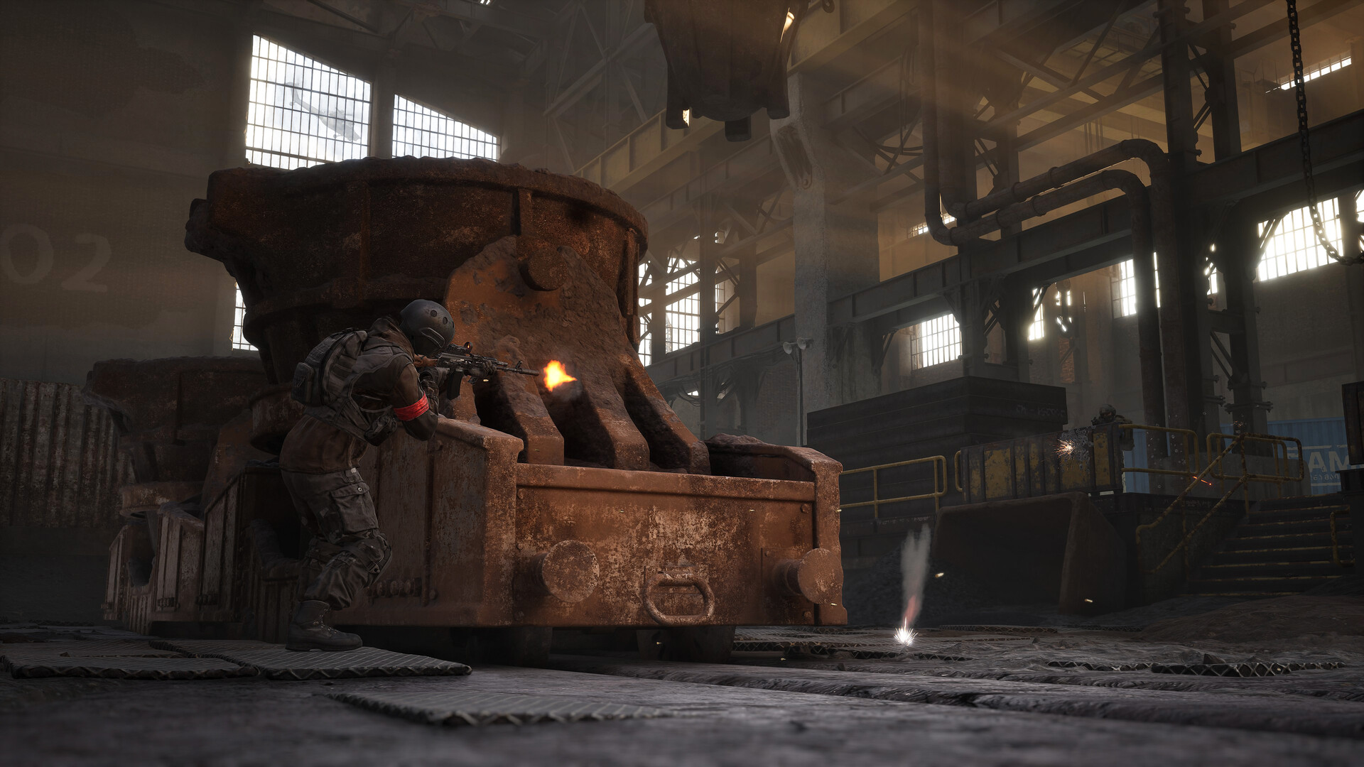 Official WARDOGS screenshot of a soldier firing from behind a steel ladle inside a factory building